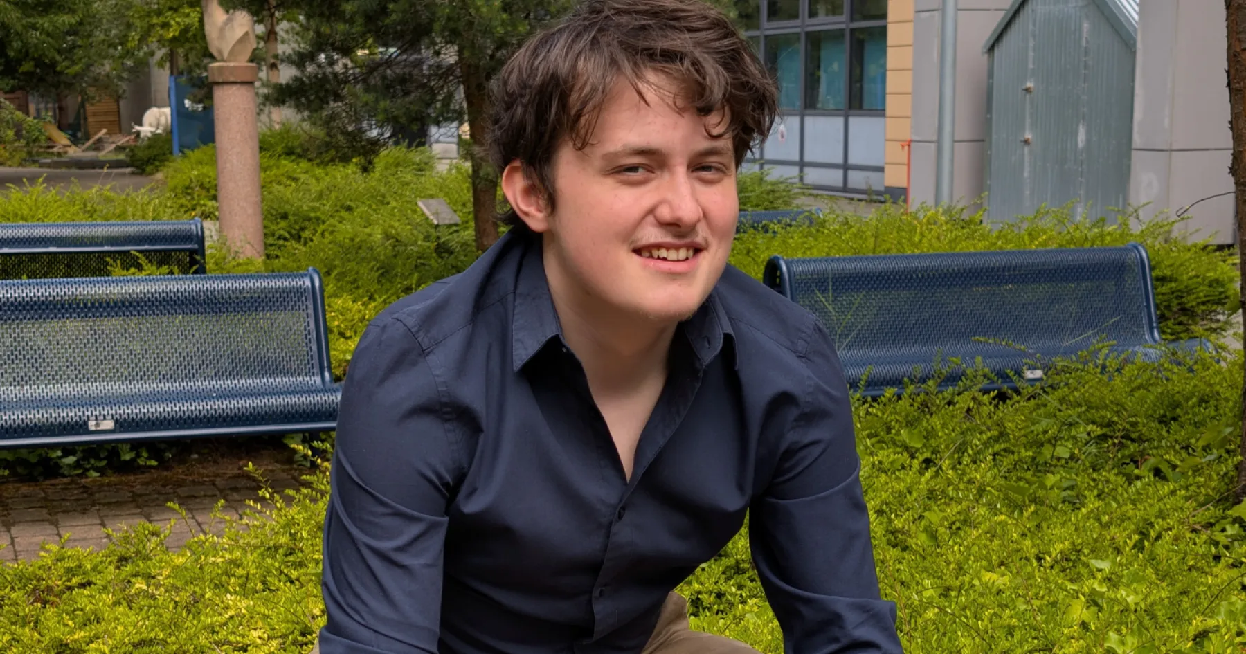 Adam Lowe, President, sitting on a bench, outside at Granton Campus