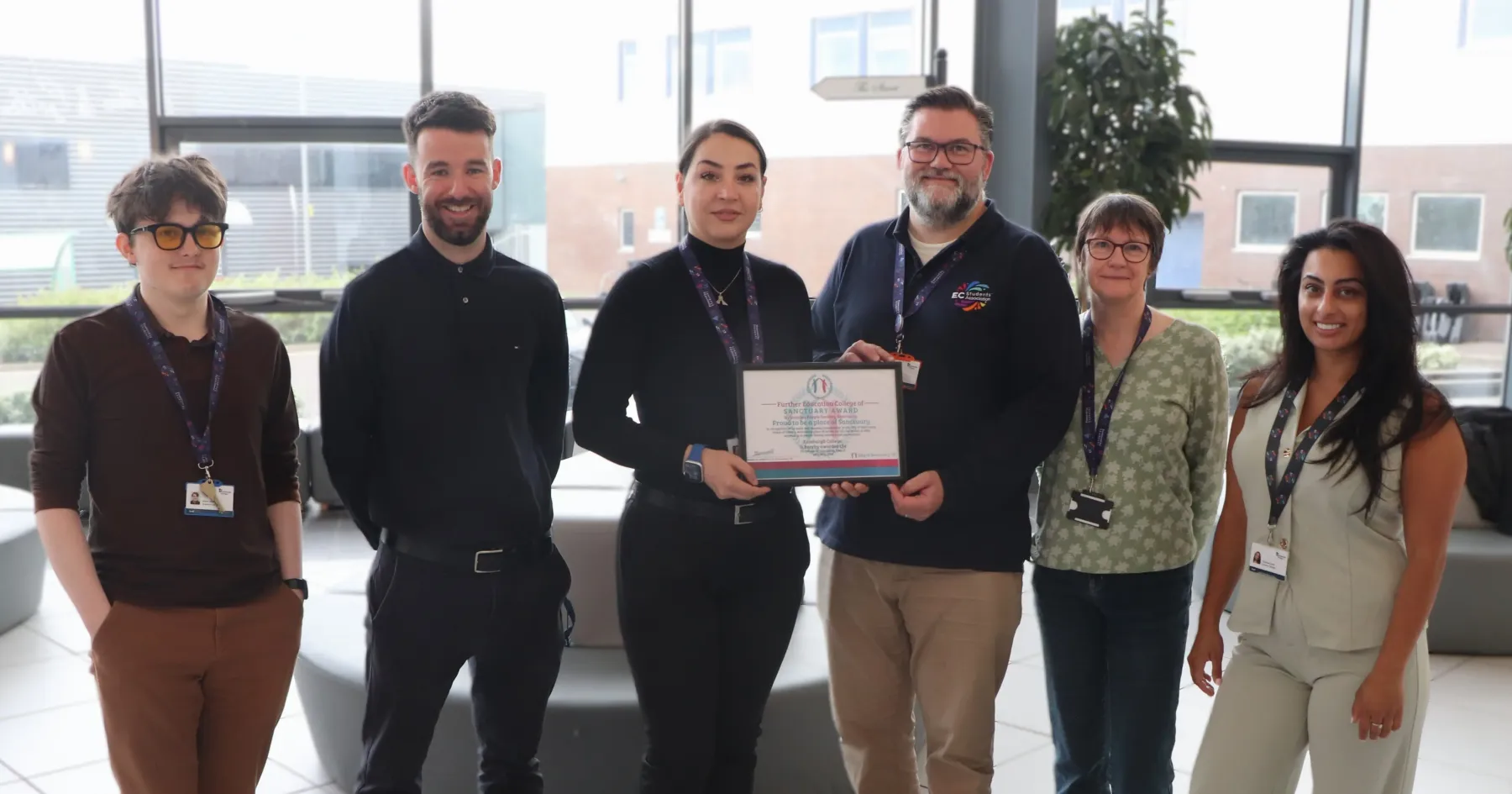 Staff from the Students' Association and the College holding our College of Sanctuary Award