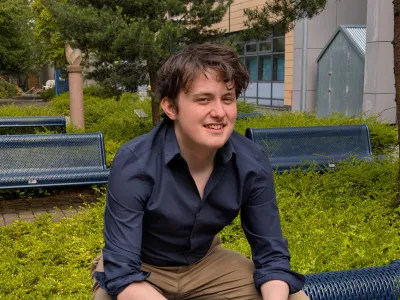 Adam Lowe, President, sitting on a bench, outside at Granton Campus