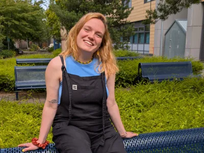 Mary O'Driscoll, Vice President Activities, sitting on a bench, outside at Granton Campus